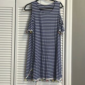 Cold shoulder with poms on hem and sleeves.